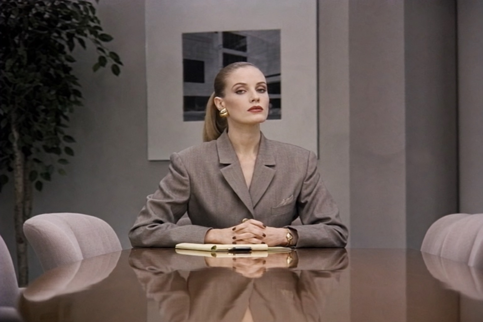 A representative of management seated at the boardroom table.